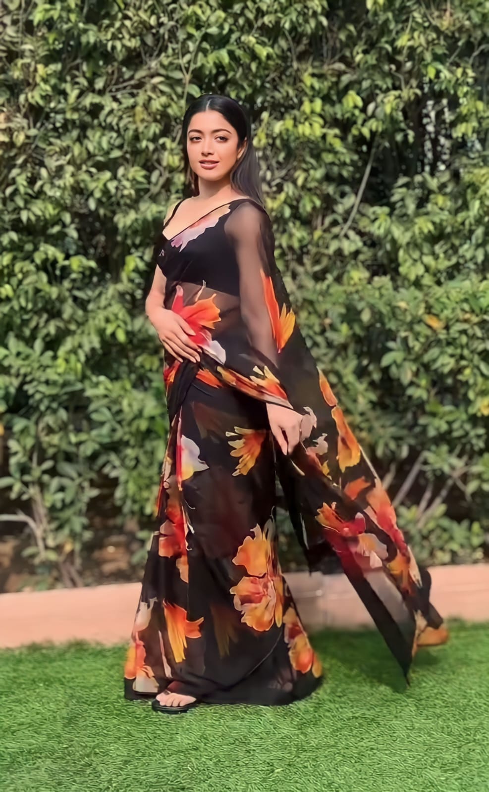 Pallu design of black printed georgette saree shown on shoulder