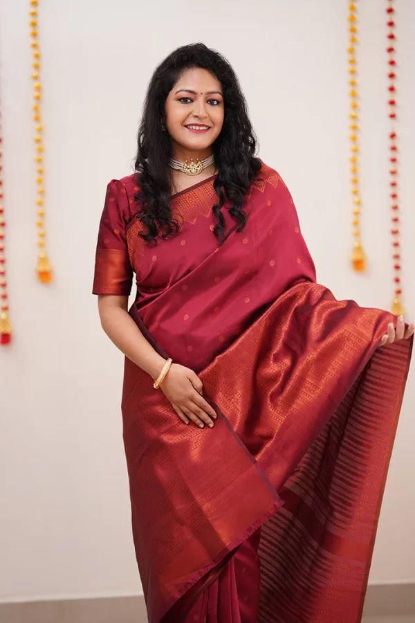 Adorning Maroon Soft Silk Saree With Gossamer Blouse Piece